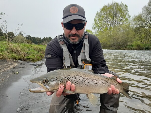 David Klee with a brown trout on Whakapapa River. Credit Fish & Game