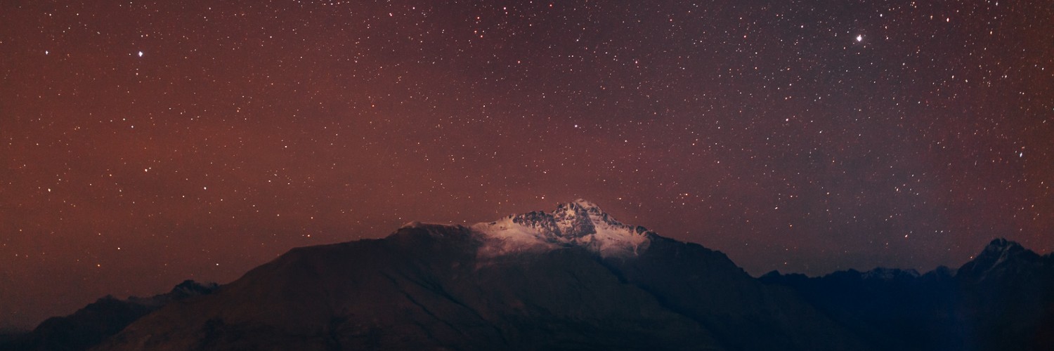 aerial view of mountain under black sky with stars, queenstown, otago