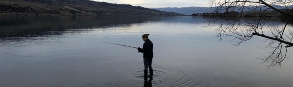 An angler stands in a river